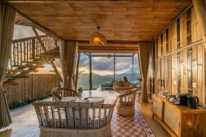a large room with a staircase in a house at The Dewi Eco Bamboo Villa in Kubupenlokan