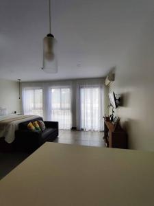 a living room with a bed and a couch at Hogar verde in Alajuela