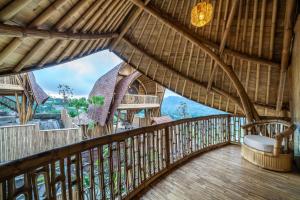 a view from the balcony of a bamboo house at The Dewi Eco Bamboo Villa in Kubupenlokan