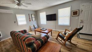a living room with a couch and a table at Cozy Space Near Rough River Lake Adventures Await in Fentress McMahan