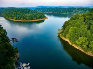an aerial view of a river with a boat on it at Cozy Space Near Rough River Lake Adventures Await in Fentress McMahan