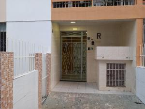 a door to a building with a gate in front at Condomínio Verdes Mares in Aracaju
