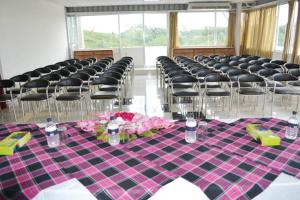 a table in a room with chairs and flowers on it at Hotel Vista Bay in Cox's Bazar