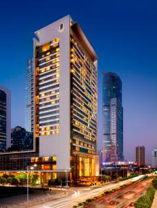 a tall building with lights on in a city at The Ritz-Carlton, Shenzhen in Shenzhen