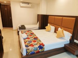 a bedroom with two beds in a room at Hotel D Tark Near IGI Airport in New Delhi