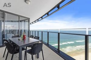 a balcony with a table and chairs and the ocean at Soul - Private Apartments - Apartment Stay in Gold Coast