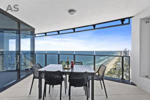 a dining room with a table and chairs on a balcony at Soul - Private Apartments - Apartment Stay in Gold Coast