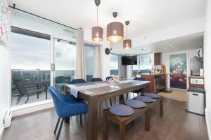 a kitchen and dining room with a table and chairs at Sub-Penthouse Apartment with Jacuzzi Pool & Sauna in Vancouver