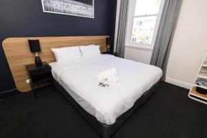 um quarto com uma cama com duas toalhas em The Albion Hotel em Wickham