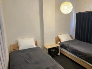 Ein Bett oder Betten in einem Zimmer der Unterkunft Oninosanpomichi