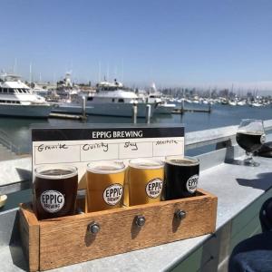three cups of beer in a wooden box on a table at Nautical Point Loma Getaway - 7 mins to airport in San Diego