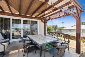 a patio with a table and chairs and a pergola at 10-Guest Home- National City Scenic Sunsets in National City