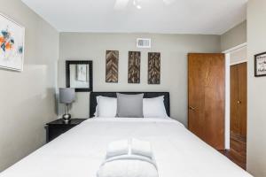 a bedroom with a large bed and a wooden door at 10-Guest Home- National City Scenic Sunsets in National City