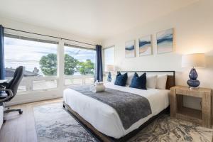 a bedroom with a bed and a large window at Sunset Serenity On The Cliffs! in San Diego