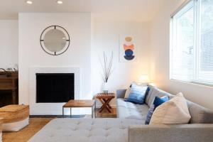 a living room with a couch and a fireplace at Sunset Serenity On The Cliffs! in San Diego