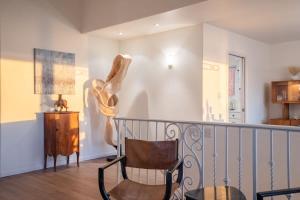 a room with a chair and a lamp on a balcony at Sunset Serenity On The Cliffs! in San Diego