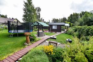 a garden with a playground and a trampoline at Vila Renata Laure in Palanga