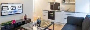 A kitchen or kitchenette at Boe Apartment Hotel