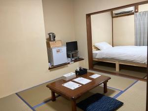Ein Bett oder Betten in einem Zimmer der Unterkunft Oninosanpomichi