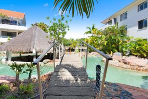 a walkway leading to a resort with a swimming pool at Noosa International Resort in Noosa Heads