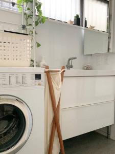 a kitchen with a washing machine and a sink at ONJUKU BEACH HOUSE - private villa 1 min walk to beach with sea view in Onjuku