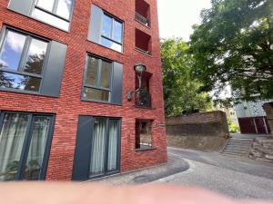 a red brick building with a window at Calvarie-studio in Maastricht