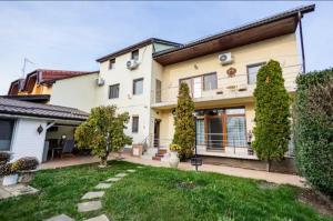 an exterior view of a house with a yard at TEXAS in Timişoara