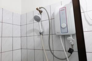 a shower with a microphone in a bathroom at Nadi Bethel Homestay in Nadi