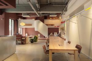 an office with a long wooden table and chairs at Mooke&Co Moganshan in Deqing