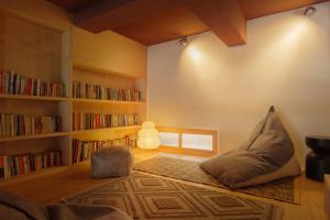 a living room with a bean bag chair and bookshelves at Mooke&Co Moganshan in Deqing