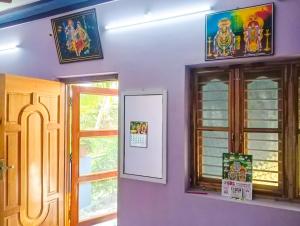 a room with two windows and a whiteboard on the wall at NAKSHATHRA Guest House 2BHK in Tiruvannāmalai