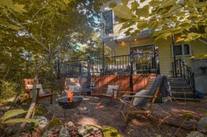 a patio with chairs and a fire pit in front of a house at Hakuba Cottage Momiji in Hakuba