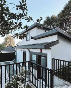 a white house with a black fence at Modern Home in Vancouver close to Downtown and Airport in Vancouver