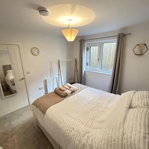 a bedroom with a large bed and a window at Southborough Suite in Kent