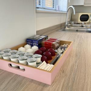 a drawer filled with different types of food in a kitchen at Southborough Suite in Kent