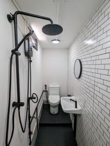 a bathroom with a toilet and a sink at Cloud9 Hometel - Entire House 3BR 170m to BTS Private Quiet & Comfy in Bangkok