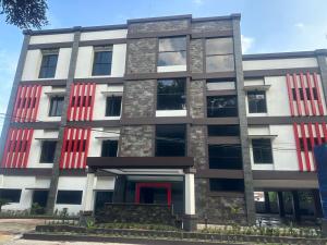 a building with red and white windows at NURIS HOTEL in Lampung
