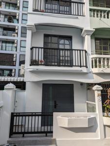 a white building with a porch and a balcony at Cloud9 Hometel - Entire House 3BR 170m to BTS Private Quiet & Comfy in Bangkok