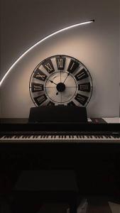 a clock sitting on top of a piano at Jriska apartment in Riyadh