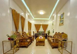 a living room with couches and a table at Drossgold Pension House in Tubigon
