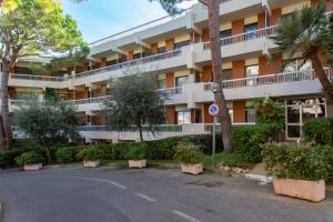an apartment building with trees in a parking lot at Sea view apartment in residence with swimming pool! in Nice
