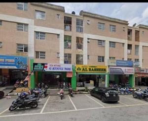 un grupo de motocicletas estacionadas en un estacionamiento frente a un edificio en Rawang Ho Budjet Homestay en Rawang