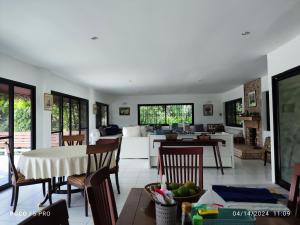 a living room with a couch and a table at Cottage by the pond in Ban Thung Khao Tok