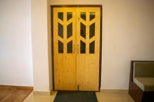 a wooden door in a room with a couch at The Grand ARK in Gangtok