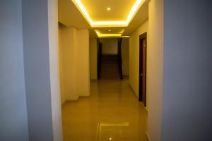a long hallway with yellow walls and a ceiling at The Grand ARK in Gangtok