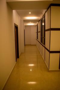 a hallway of an apartment with a wooden floor at The Grand ARK in Gangtok