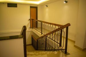 a staircase in a building with a wooden railing at The Grand ARK in Gangtok