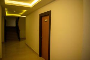 a hallway with a door and stairs in a building at The Grand ARK in Gangtok