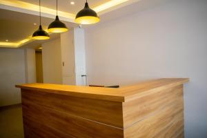a reception desk in a room with three lights at The Grand ARK in Gangtok