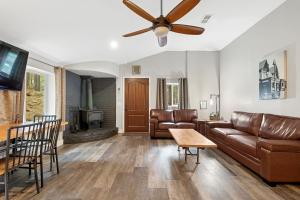 a living room with a couch and a ceiling fan at The Cozy Cottage in Flagstaff